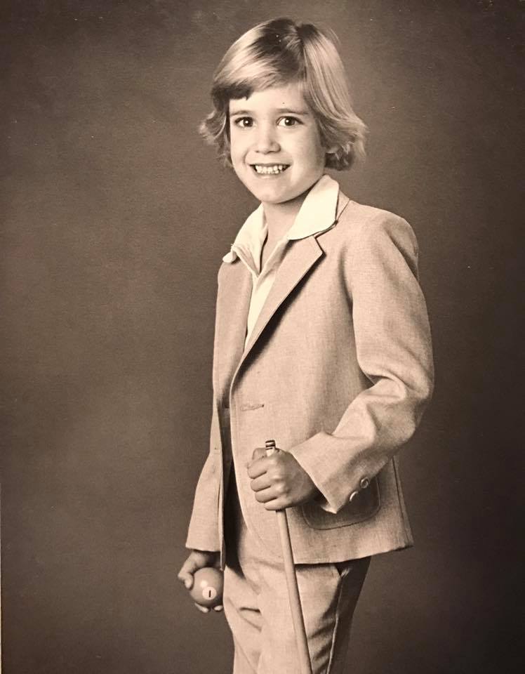 Black and white photo of Mark-Paul Gosselaar in a formal suit.